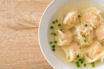 shrimp dumpling soup in white bowl