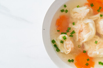 shrimp dumpling soup in white bowl