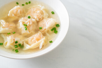 shrimp dumpling soup in white bowl