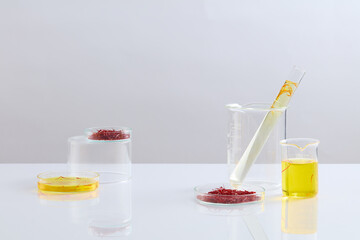 Laboratory glassware containing saffron and liquid decorated on the white background. People would eat saffron to boost mood, and improve memory