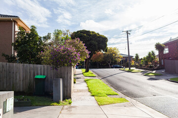 street scene with footpath and homes in daylight