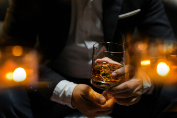 Closeup businessmen holding a glass of whiskey