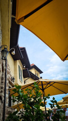 Italian style street with yellow umbrellas 