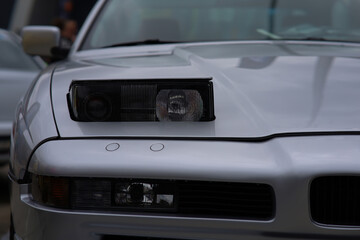 retractable headlight close-up on a gray sports car
