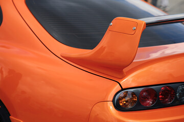 Orange tuned sports luxury car fragment. Sport car at the start.