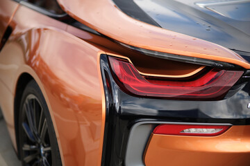 Orange tuned sports luxury car fragment. Sport car at the start.