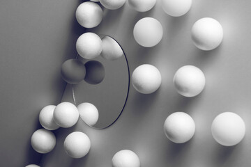 dimensional compositions of geometric shapes concept.white balls on mirror on grey background....