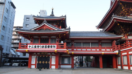 A traditional red Japanese temple in the middle of Nagoya Japan