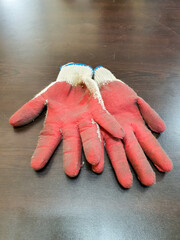 Used red and white gloves lay on the table.