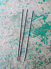 Three connecting rods laying on the ground