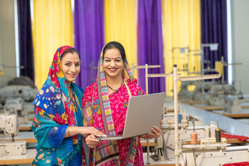 Indian women using laptop at workplace, online learning concept.