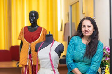 Indian female fashion designer standing at her shop