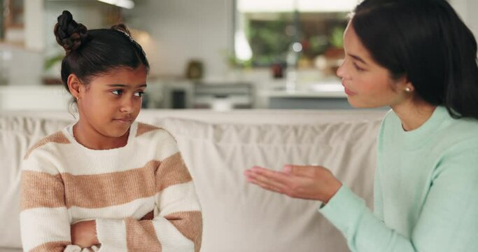 Talking, mother and discipline upset child for bad behaviour, problem or mistake on a home sofa. Sad young girl kid listening to a woman, parent or family speaking to lecture, advice or punish