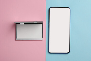 Metal box business card holder with smartphone on pink blue background. Top view