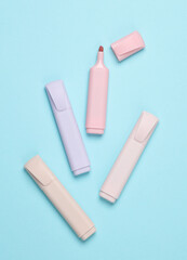 Markers or colored felt-tip pens on a pastel background. Creative layout