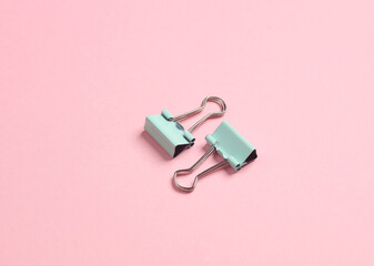 Paper clip holders on a pink background. Minimalism