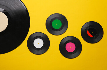 Retro vinyl records on yellow background