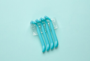 Set of plastic razors on a paper background