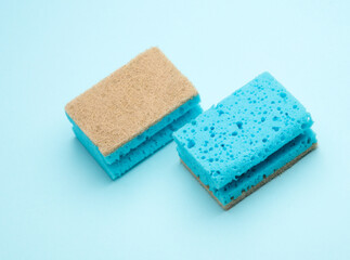 Two cleaning sponges on blue background