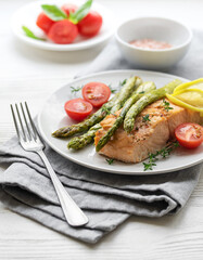 Baked Delicious salmon, green asparagus on  plate