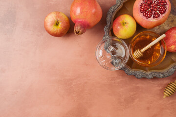 Jewish holiday Rosh Hashanah flat lay composition with honey, apple and pomegranate on vintage...