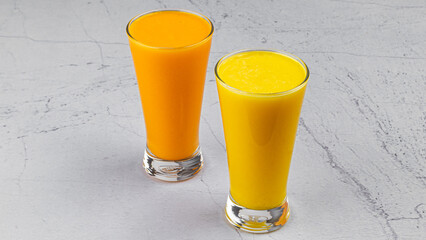 a luscious mango smoothie and a creamy mango lassi and organge juice