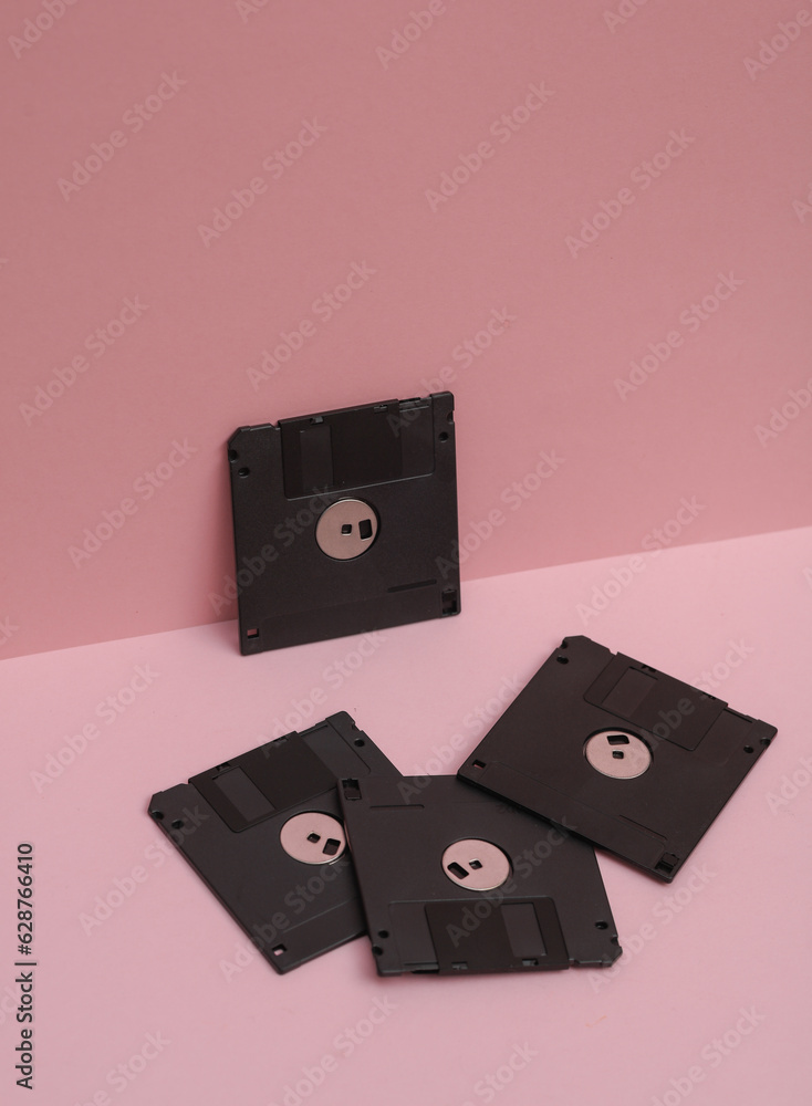 Poster outdated technologies. retro 80s floppy disks on pink background. creative layout