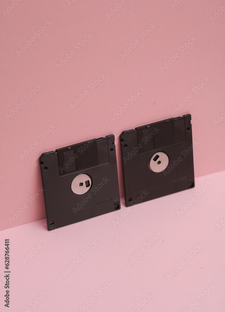 Poster outdated technologies. retro 80s floppy disks on pink background. creative layout