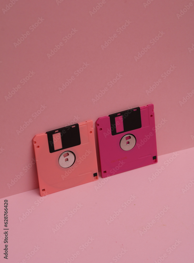 Poster outdated technologies. retro 80s floppy disks on pink background. creative layout