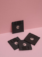 Outdated technologies. Retro 80s floppy disks on  pink background. Creative layout