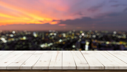 Fototapeta na wymiar Wood table front view with blank city sunset background for product display