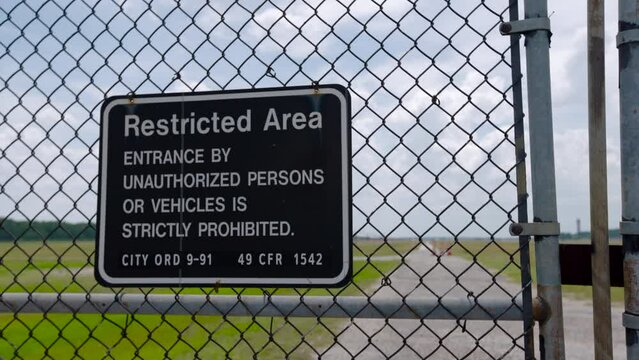 Airport Property Line Sign With Plane Landing In Background
