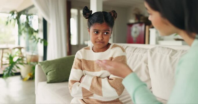 Upset child, mother and talking to discipline naughty bad behavior or mistake on a home sofa. Sad young girl kid with a woman, parent or family speaking to reprimand, lecture and advice or punish