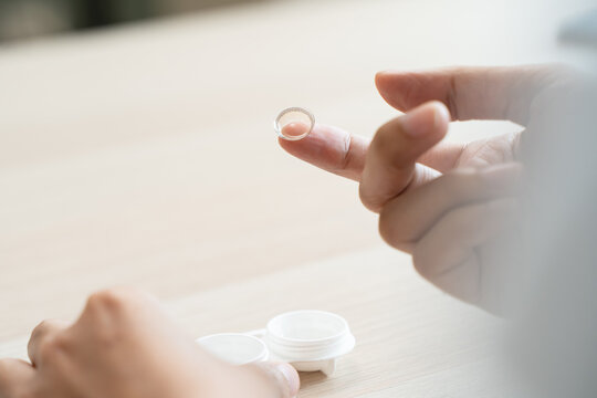 Optimise vision by contact lens, Close-up of woman face during insert contact lens to her eyes.
