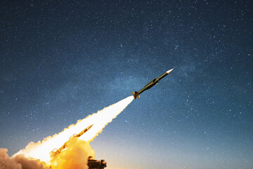 Nuclear missile with smoke and blast launching towards the target on the starry sky. Weapons,...