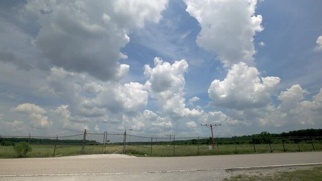 Airplane Crossing Road And Fence On Approach To Airport