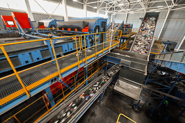 Trash transported by conveyor in recycling plant workshop