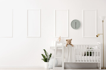 Interior of light bedroom with baby crib and changing table - obrazy, fototapety, plakaty