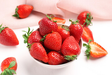 Bowl with fresh strawberries on white background