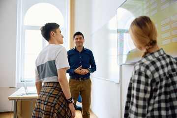 Obraz premium High school student using smartboard during during class in classroom.