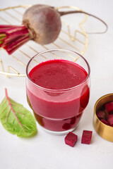 Glass of fresh beetroot juice on white background