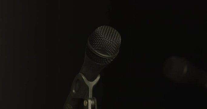 Microphones appear, illuminate, elegantly fade into obscurity
