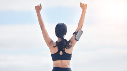 Fitness, celebration and woman with arms up in cloudy sky, mockup and winning achievement in nature. Ocean, goals and exercise girl for workout motivation, winner victory and success in natural space