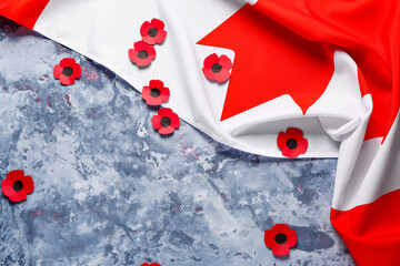 Poppy flowers with flag of Canada on grunge blue background. Remembrance Day