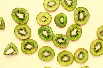 Fototapeta premium Slices of fresh kiwi on yellow background