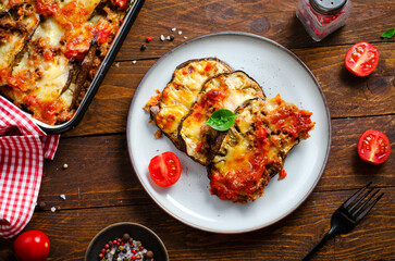 Eggplant Casserole, Roasted Eggplant Dish with Minced Meat, Tomato Sauce and Mozzarella over Rustic Background