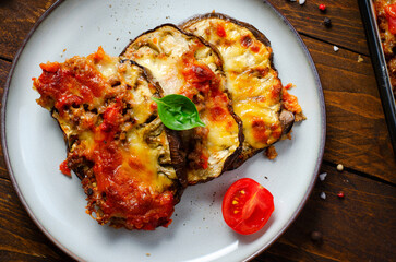 Eggplant Casserole, Roasted Eggplant Dish with Minced Meat, Tomato Sauce and Mozzarella over Rustic Background