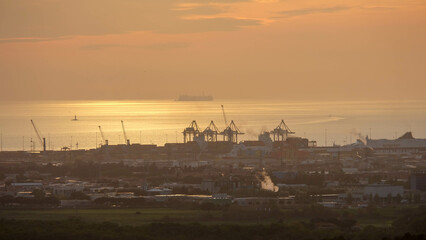 Strand von Livorno in Italien mit Industriehafen bei Sonnenuntergang Abendrot