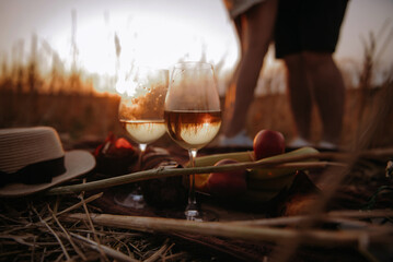 young couple having a picnic at sunset