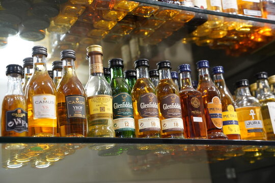 Prague, Czech Republic  - July 08, 2023:  Small alcohol bottles - Glenfiddich whiskey, Metaxa brandy.